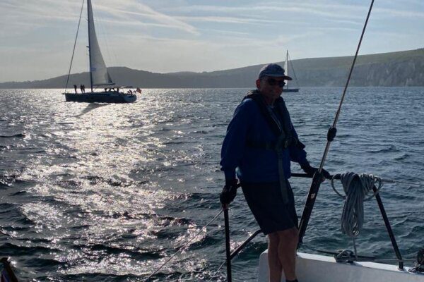 Man at back on yacht on Ancasta Yacht Club Rally to Cherbourg 2023